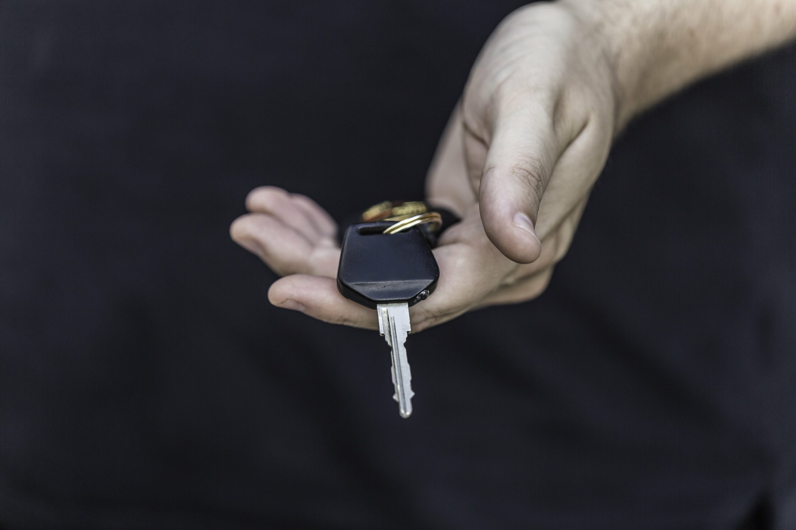 Hand holding a vehicle key